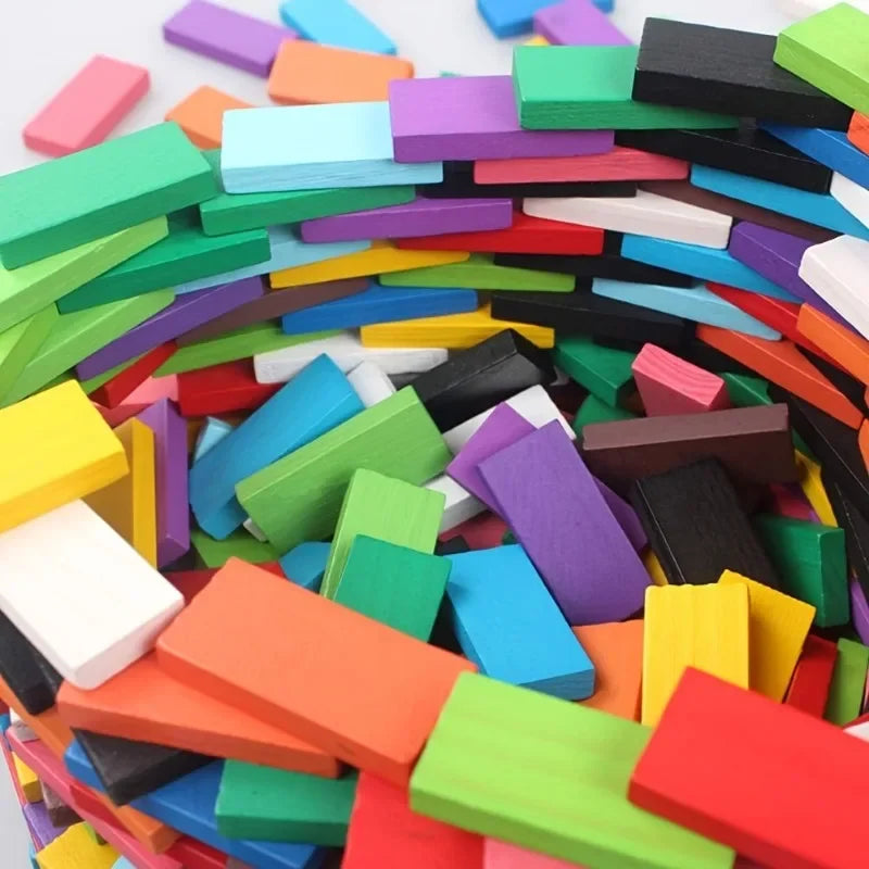 A large pile of multicolor wooden domino building blocks in various colors and shapes.