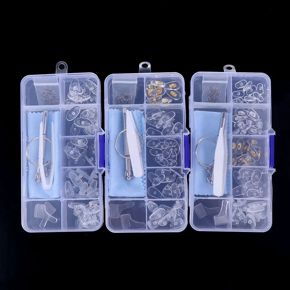 A clear plastic kit containing various precision tools, screws, and nose pads for repairing glasses.