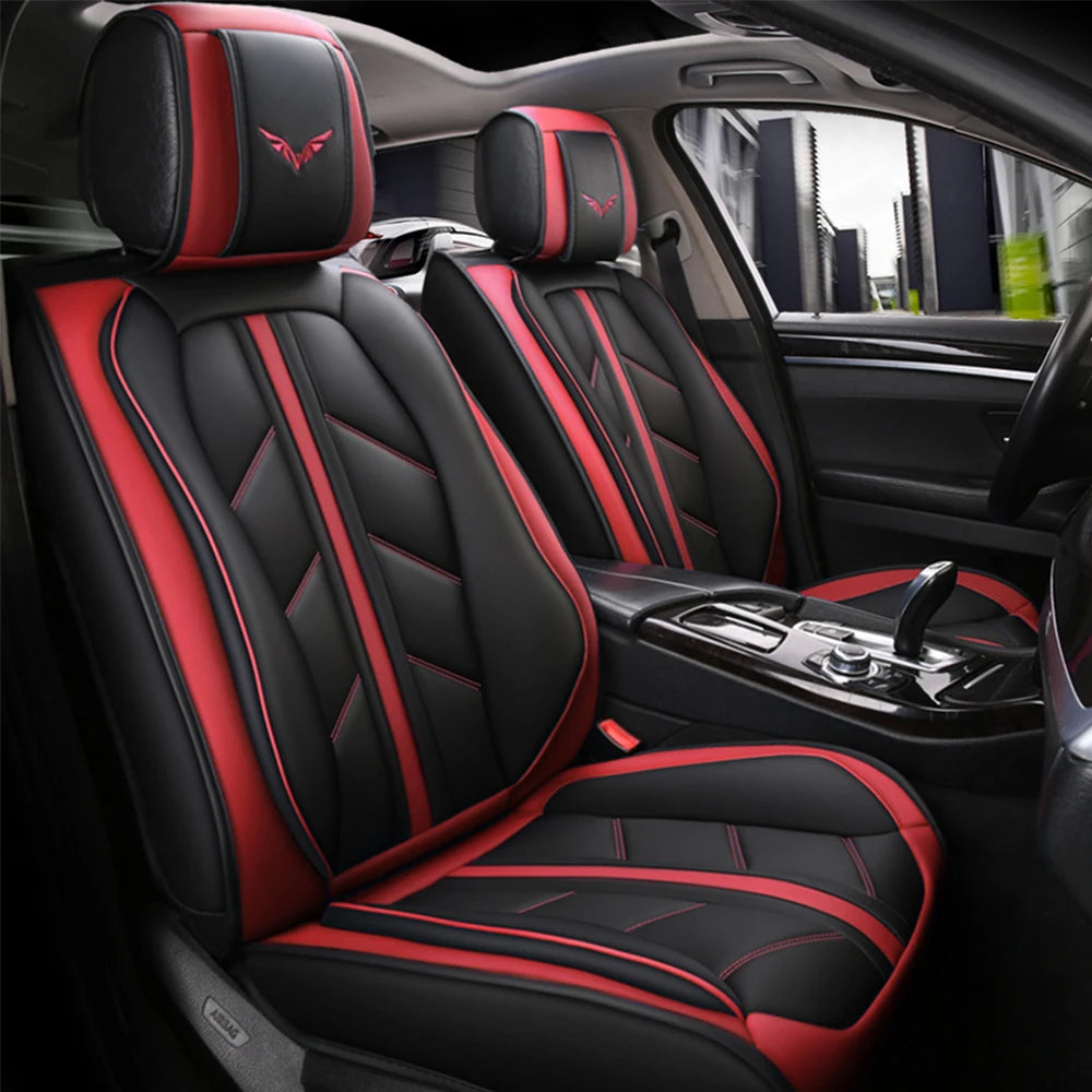 Black and red leather car seat covers with matching headrests installed in a vehicle interior.