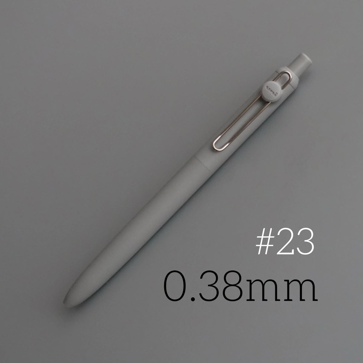 A close-up view of a light gray Uni ZENTO Quick-Dry Gel Pen with a 0.38mm tip.