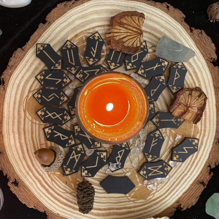 A wooden rune stone divination set with various stones arranged on a cross-section of a tree trunk.
