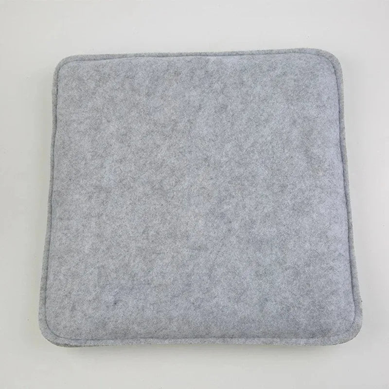 A square, gray felt mat used for wool crafting.