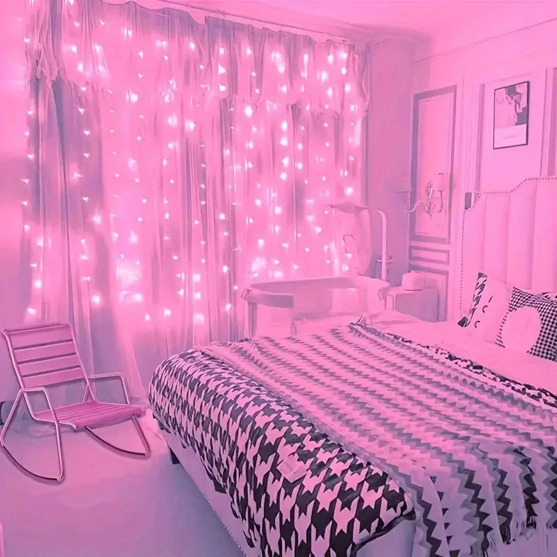 A bedroom decorated with pink LED curtain string lights illuminating sheer curtains and a bed.