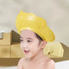A yellow adjustable baby bath shampoo shield cap is shown on a child, with icons indicating safety features.