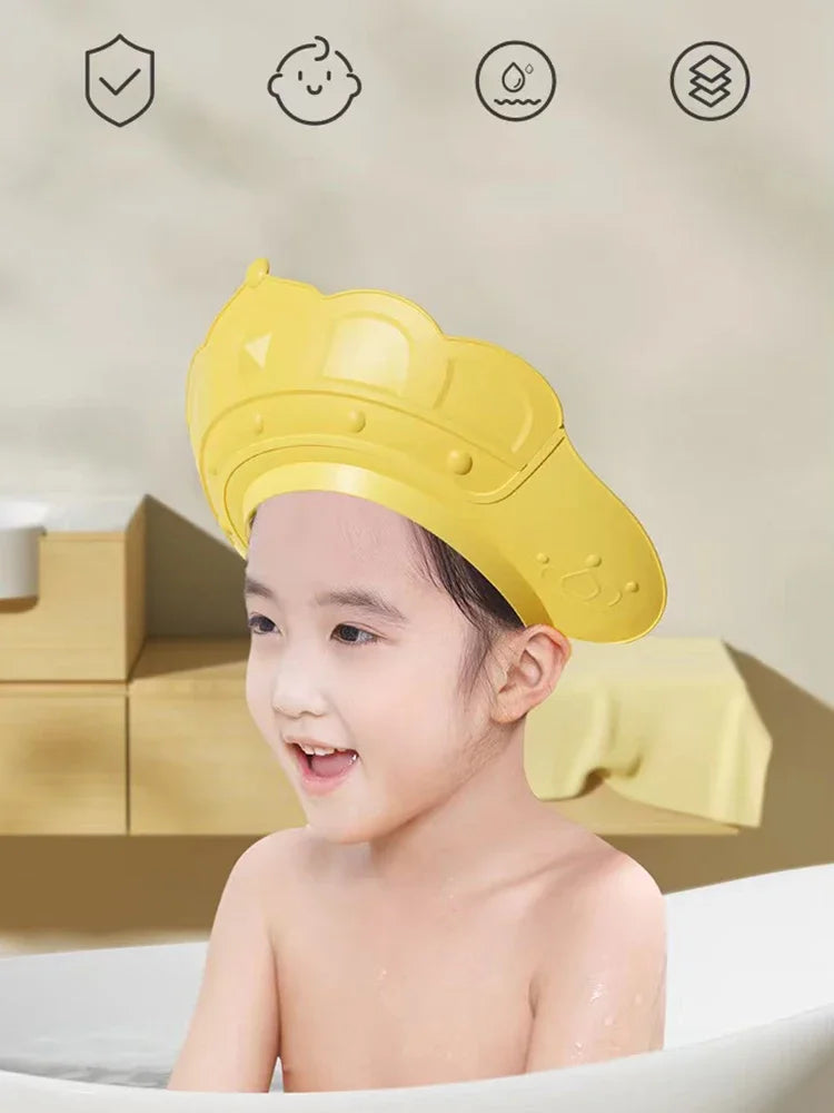 A yellow adjustable baby bath shampoo shield cap is shown on a child, with icons indicating safety features.