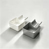 A pair of white and gray washing machine drain funnels with overflow guards and drip pans shown on a light surface.