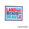 A rectangular embroidered patch with blue and red text that reads Land of the Brave