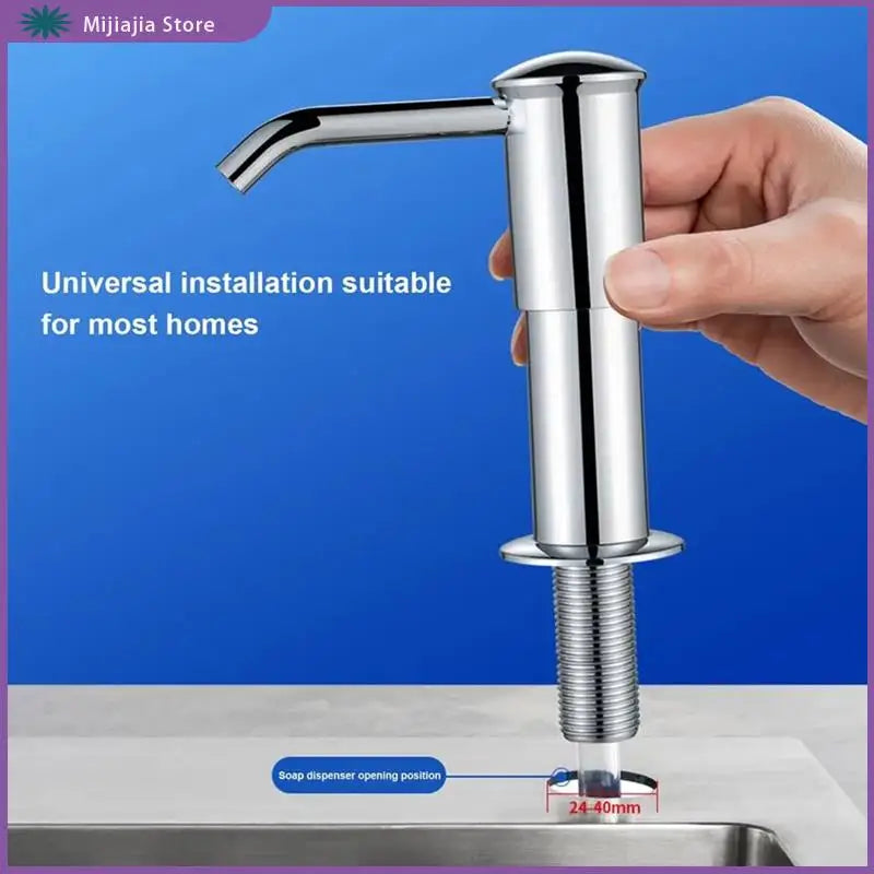 A hand holds a chrome kitchen sink soap dispenser extension kit, showing the faucet and threaded base.