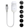 A white 2-in-1 mini projector night light with a USB connector and multiple star patterns displayed on the side.