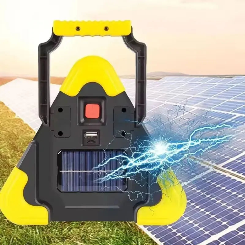 A yellow and black solar emergency triangle warning light with a built-in flashlight is placed on a solar panel.