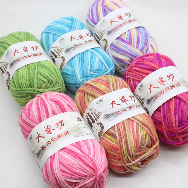 A collection of brightly colored yarn skeins with Chinese text labels is displayed on a white background.