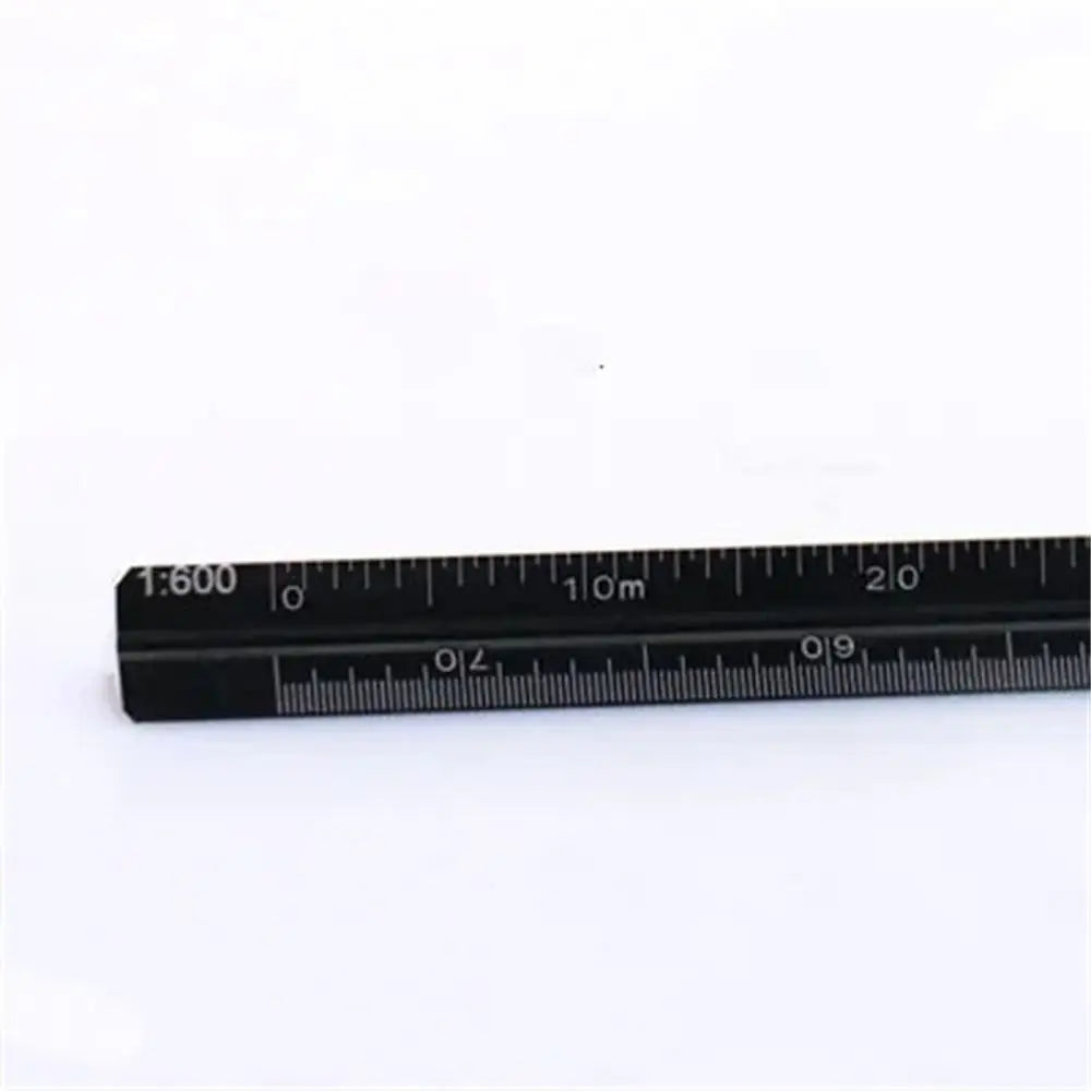 A close-up view of a black aluminum triangular scale ruler with metric markings.
