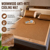 A brown anti-mite cooling mat is placed on a bed, with botanical ingredients and soft textures shown.