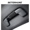A close-up view of a gray Audi Alcantara grab handle protector cover with a black strap and card pocket.