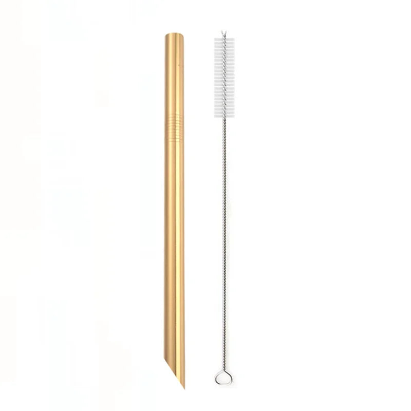 A tall, gold-colored reusable stainless steel drinking straw with a cleaning brush.