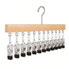 A wooden clip hanger with 12 metal clips for holding scarves, ties, and other items.
