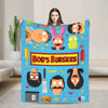 A colorful cartoon-themed throw blanket featuring various funny character faces and food items.