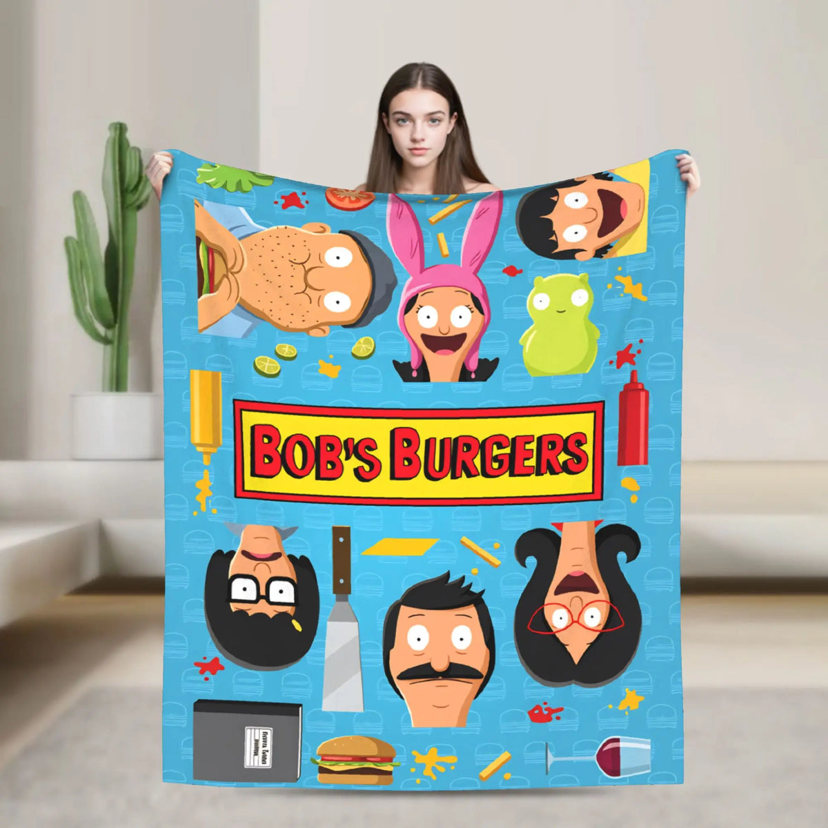 A colorful cartoon-themed throw blanket featuring various funny character faces and food items.
