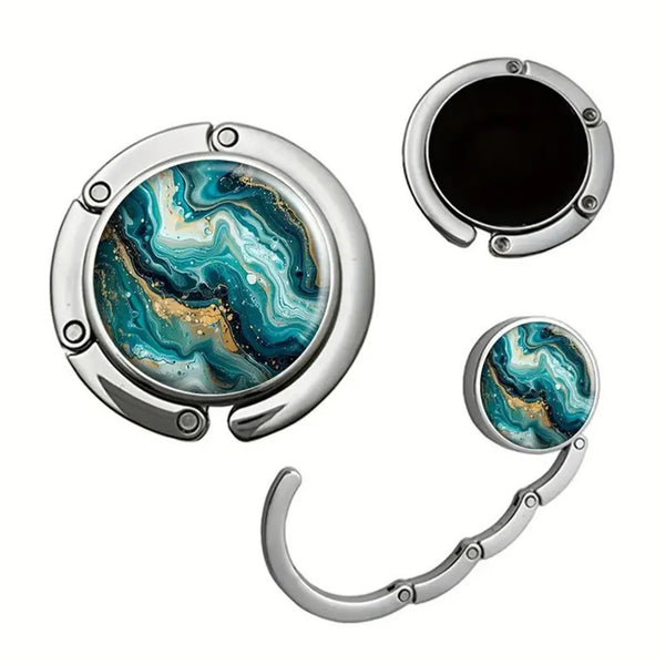 Silver bag hook with a circular opening and a curved handle, featuring an iridescent blue and gold marbled pattern.