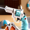 A white and orange mechanical burst revolver water gun is shown with a blue water stream, resting on a wooden surface.