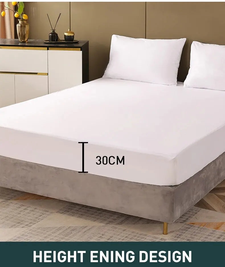 A white fitted mattress protector with an elastic edge is shown on a bed, highlighting its 30cm height design.
