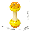 A yellow baby sensory spinning rattle toy set with an orange top and a light yellow base.