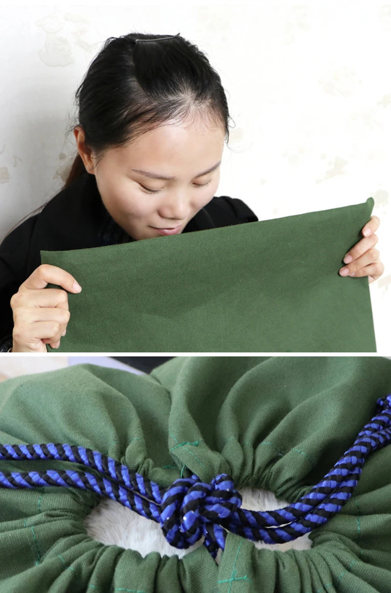 A close-up of a dark green heavy-duty canvas laundry bag with a blue drawstring closure.