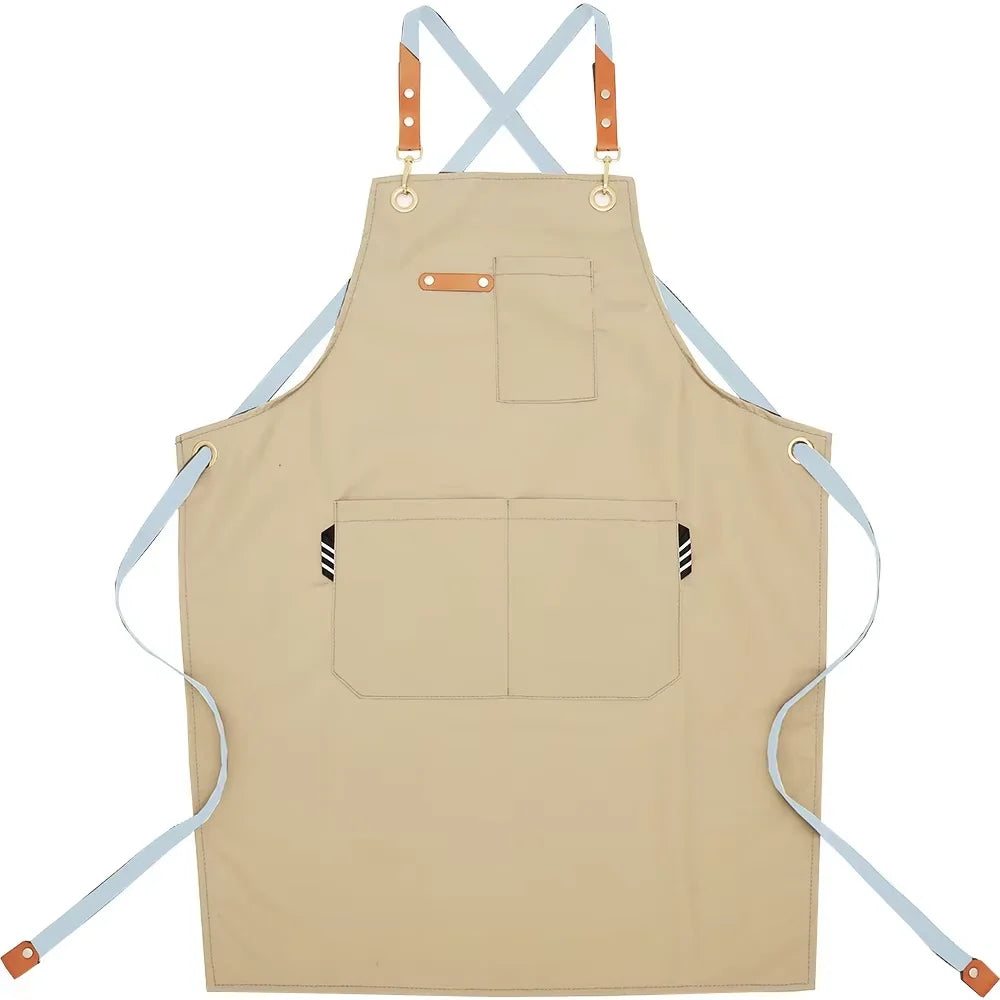 A beige cotton canvas apron with adjustable straps and multiple pockets for kitchen or salon use.