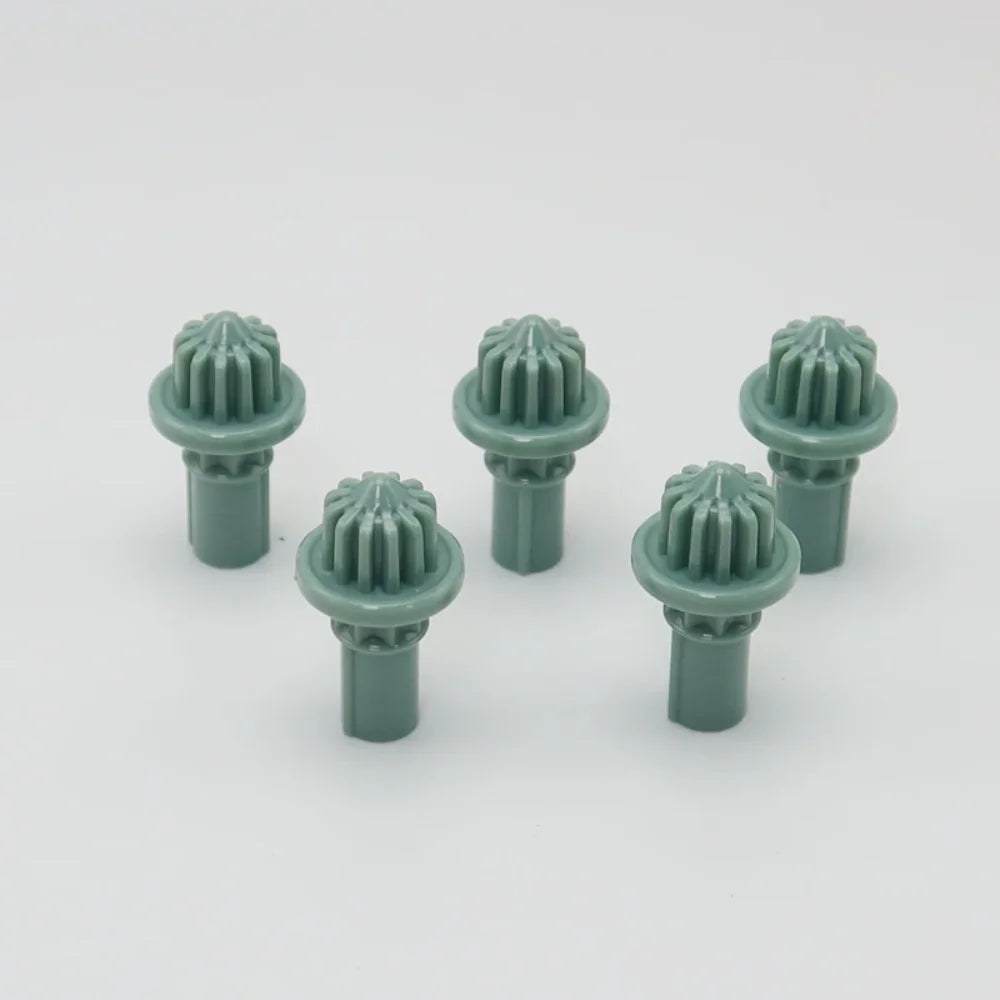 A set of five green replacement drivers for a Takara Tomy battling top.