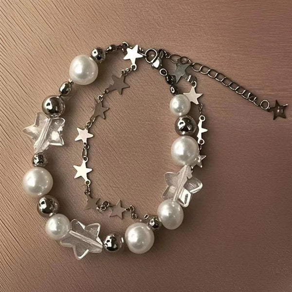 A double-layer bracelet featuring silver chains, clear crystals, and white pearls.