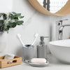 A set of four bathroom accessories including a soap dispenser and holder on a white countertop.