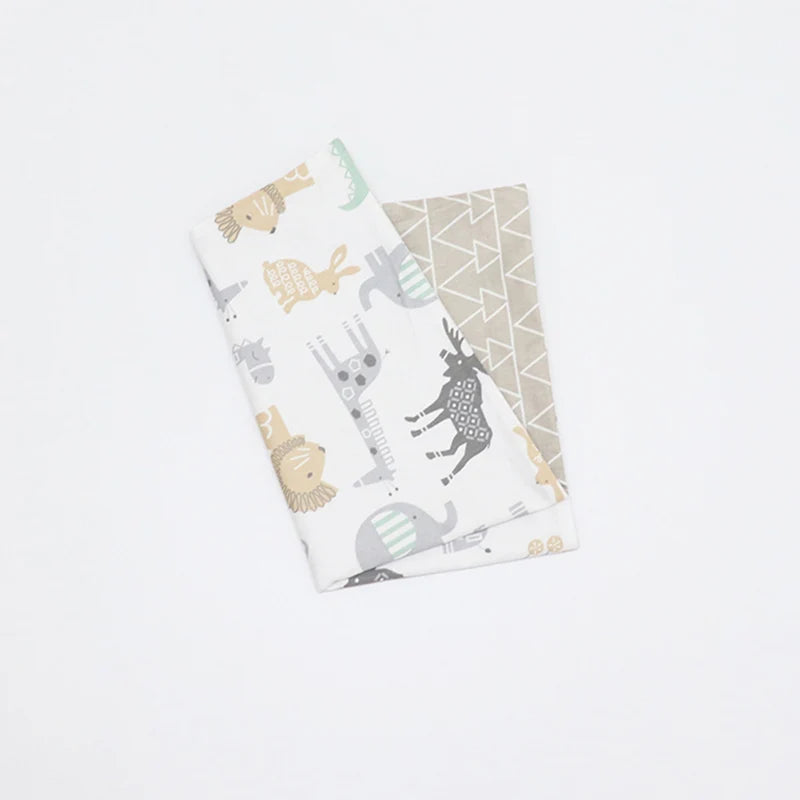 A folded soft cotton baby pillowcase featuring a cartoon animal design on a white background.