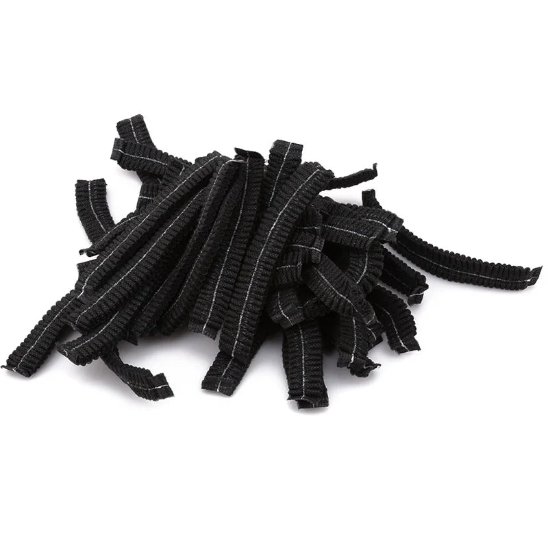 A pile of black disposable non-woven hair net caps.