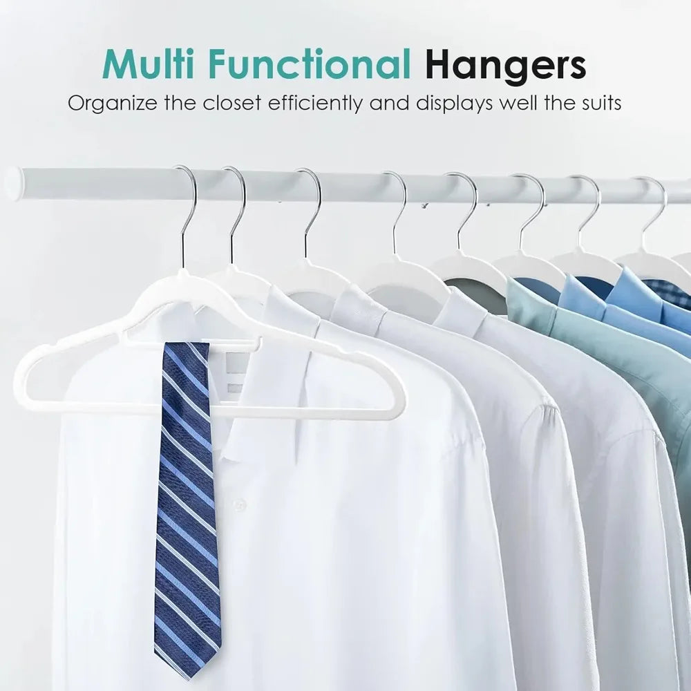 White velvet non-slip hangers displaying various suits and shirts on a wooden rack.