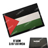 A black rectangular flag patch featuring a white stripe and a green stripe, with a red triangle on the left.