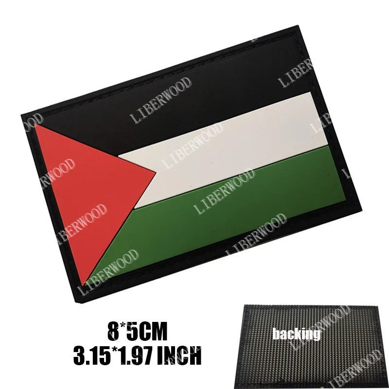 A black rectangular flag patch featuring a white stripe and a green stripe, with a red triangle on the left.