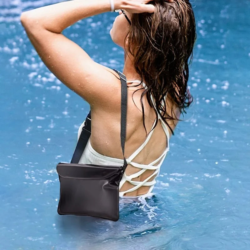 A woman with wet hair is wearing a black waterproof phone pouch while in blue water.