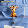 A 2D acrylic flat figurine of a baby giraffe holding an orange straw, displayed against a blue fabric.