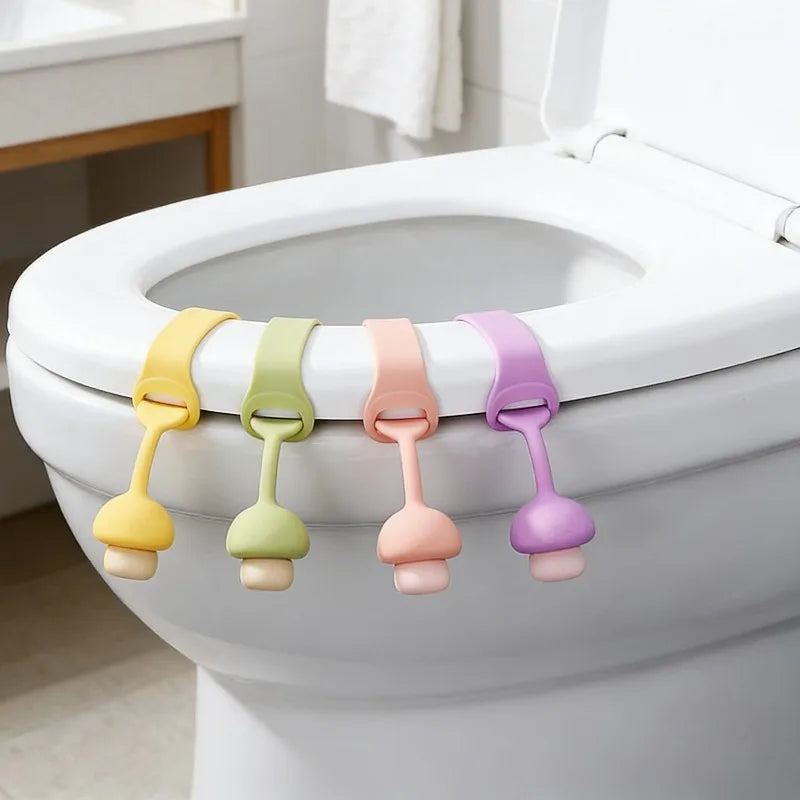 A set of colorful silicone toilet seat lifters with pull rings displayed on a white toilet tank.