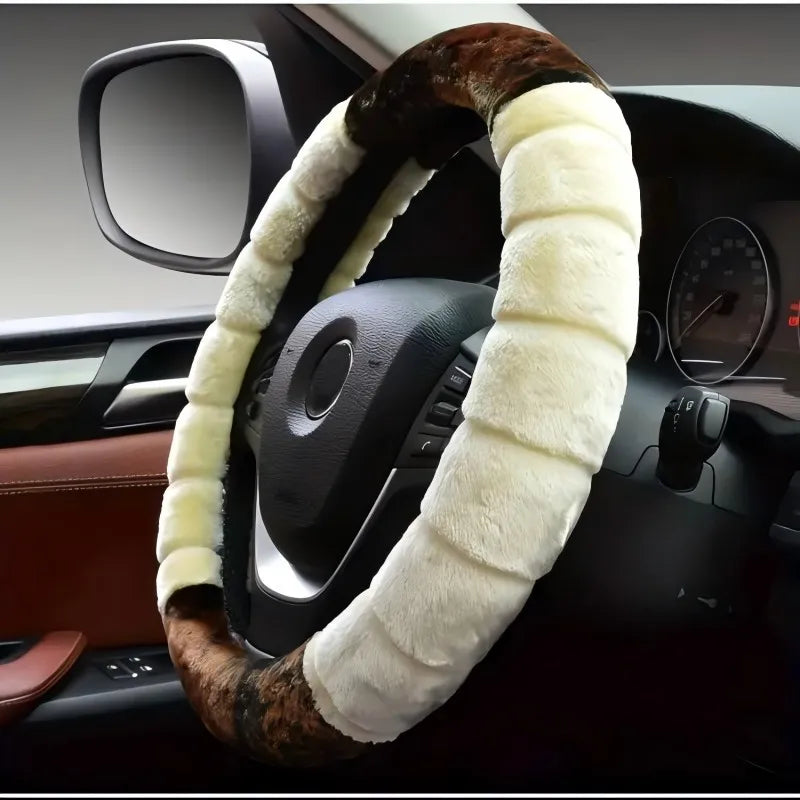 A steering wheel covered in a plush, brown and cream cartoon animal-themed fabric.