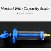 A blue air conditioning oil and dye injector with a capacity scale, shown horizontally on a black background.
