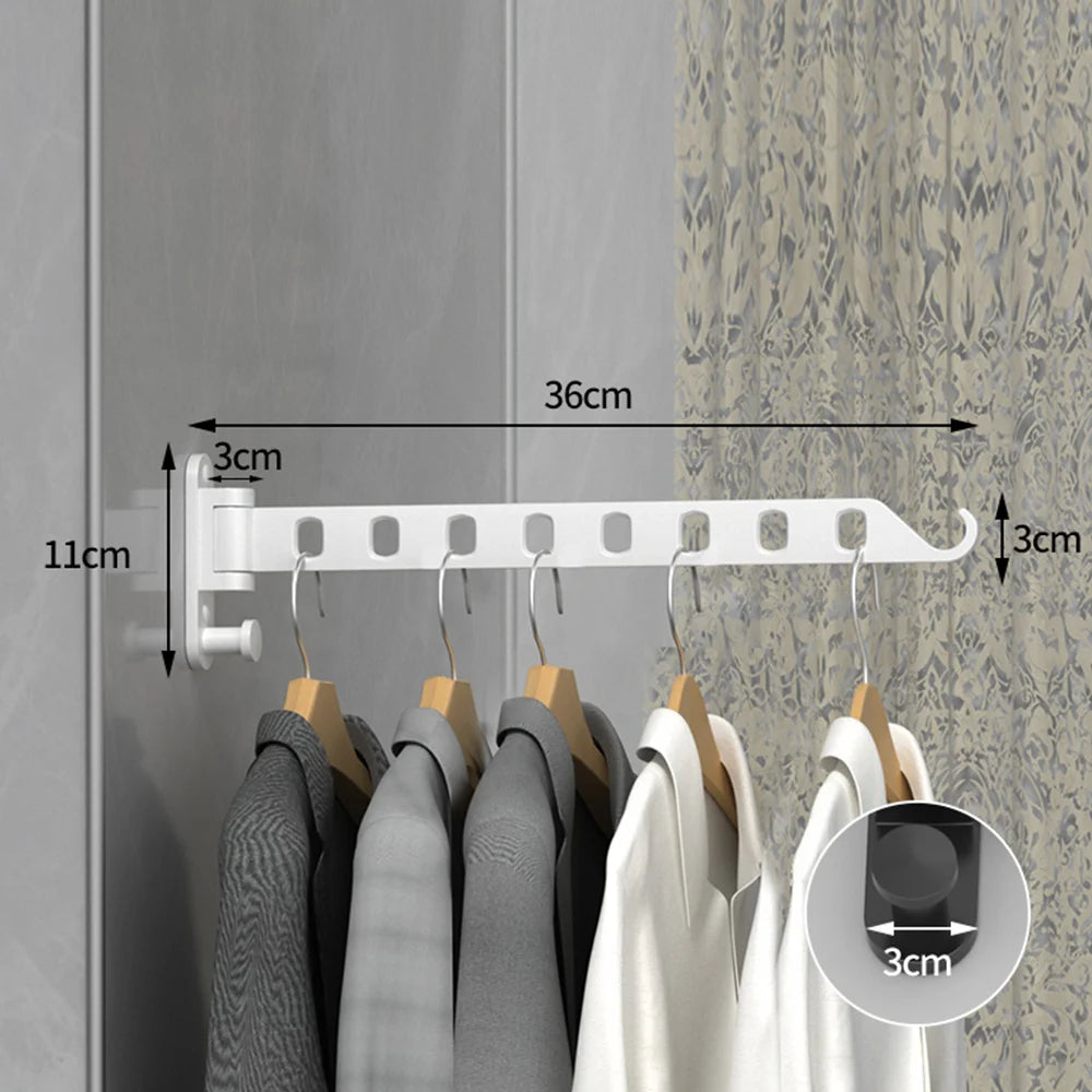 A white wall-mounted clothes drying rack with hangers is shown against a gray wall, demonstrating its size and function.