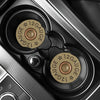 Close-up view of two absorbent leather car cup holder mats with a star pattern and gauge markings.