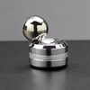 A silver metal desk spinner featuring a smooth ball on a rotating base.