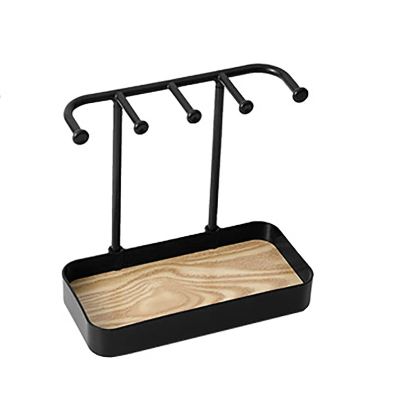 Black jewelry display rack with a drawer and wooden base featuring multiple hanging rods.