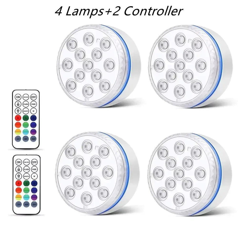 Four submersible LED pool lights and two controllers for underwater lighting.