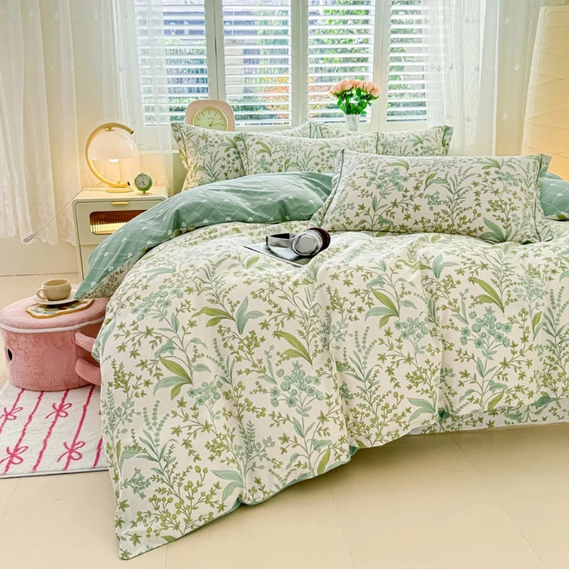 Hellgrüne Blumen-Duvetcover mit weißem Hintergrund auf einem Bett in einem hellen Raum.