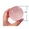 A hand holds a clear pink squishy stress relief toy with a 6cm diameter measurement.