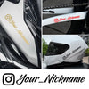 Close-up of a white motorcycle helmet featuring a custom name decal sticker on the side.