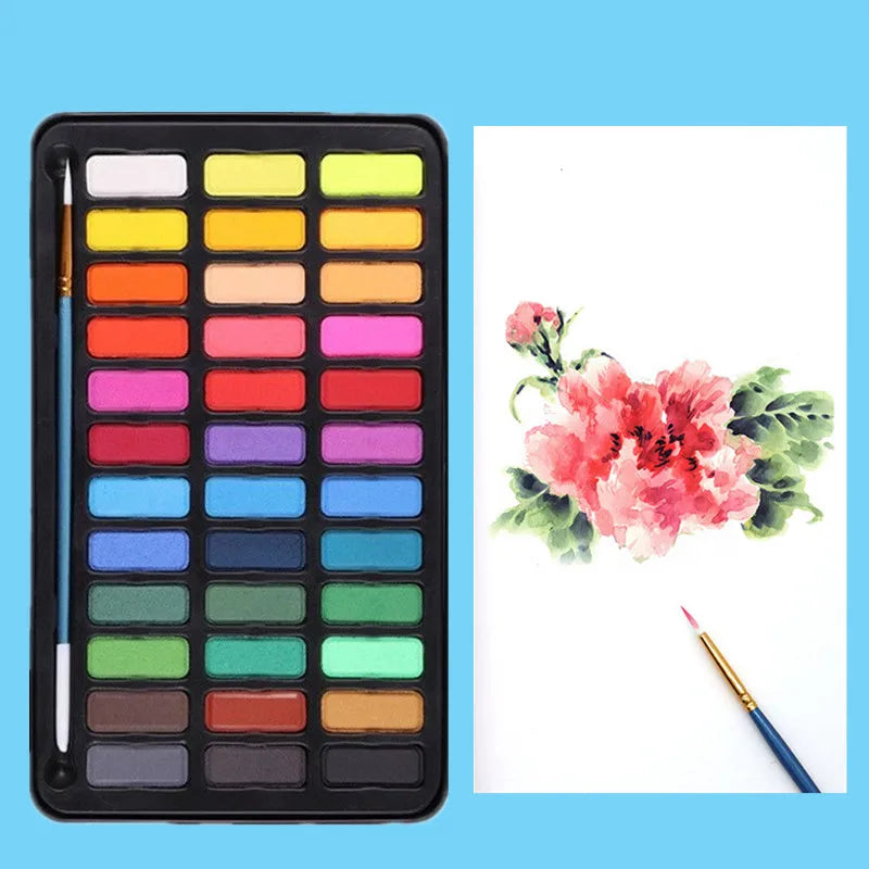 A professional watercolor paint set with a black metal case showing various colors arranged in a grid.